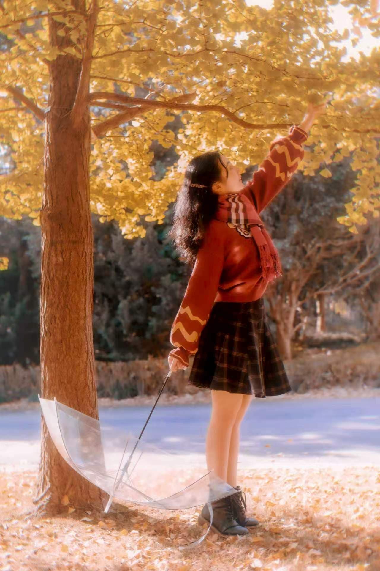 Portrait of Ziyi Chen beneath golden autumn leaves