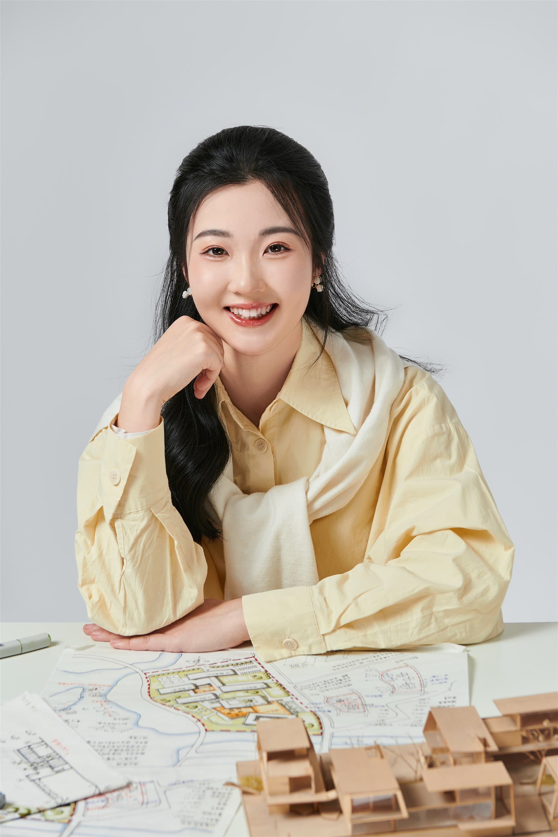 Portrait of Ziyi Chen at an architectural worktable